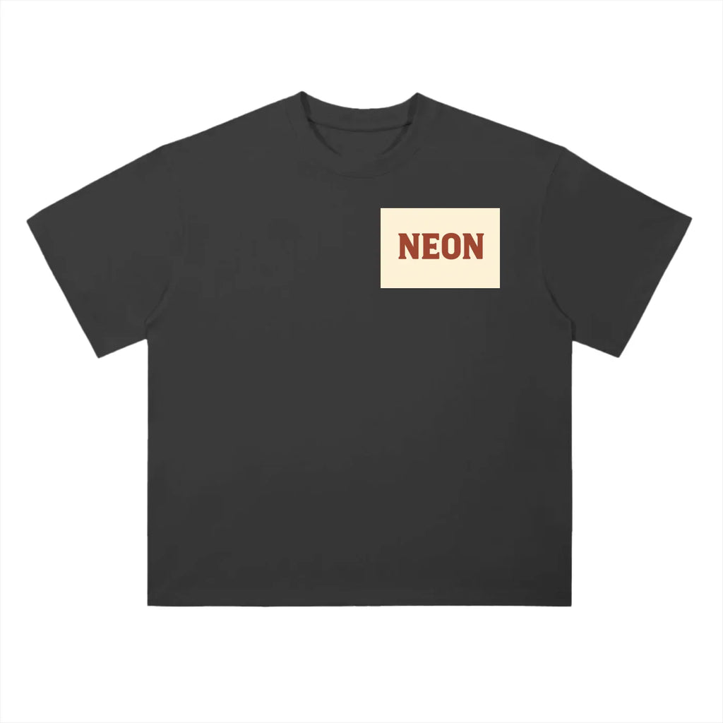 Black oversized t-shirt with cream chest patch and bold NEON text in red.
