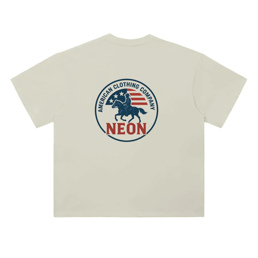 Beige t-shirt with American Clothing Company NEON logo, cowboy on horse, and flag graphic on back