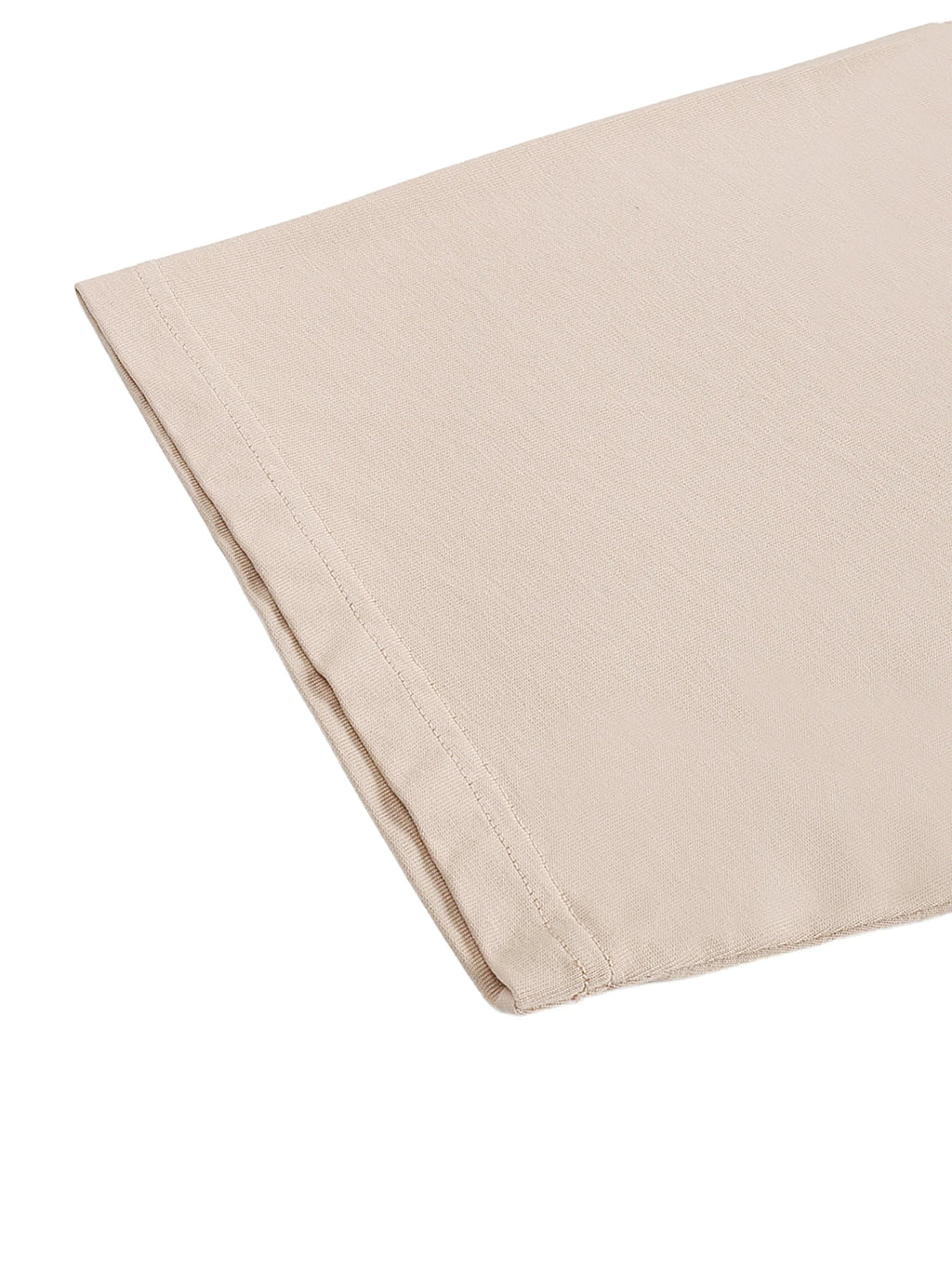 Close-up of beige cotton fabric with stitched edge on white background